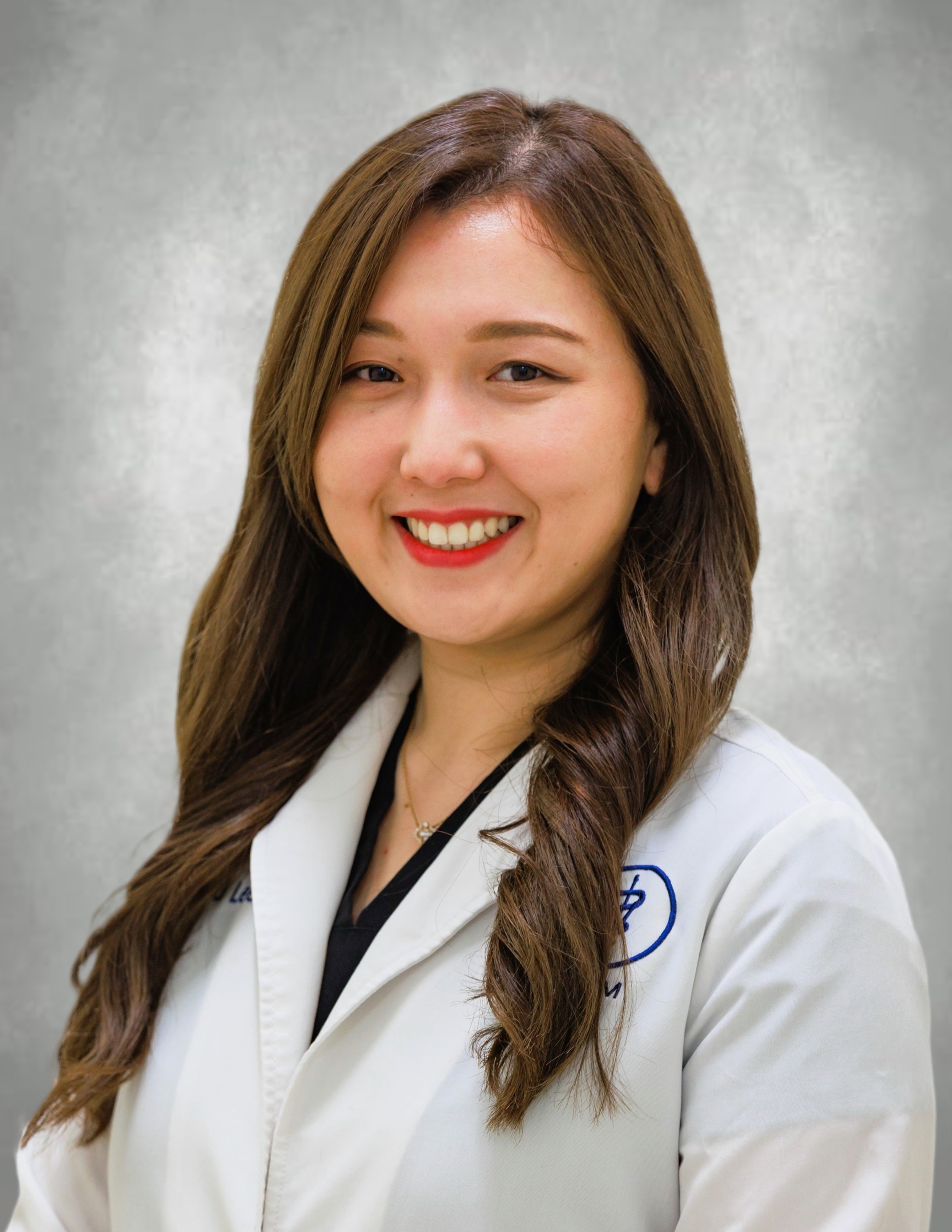 Dr. Lee smiling in her lab coat